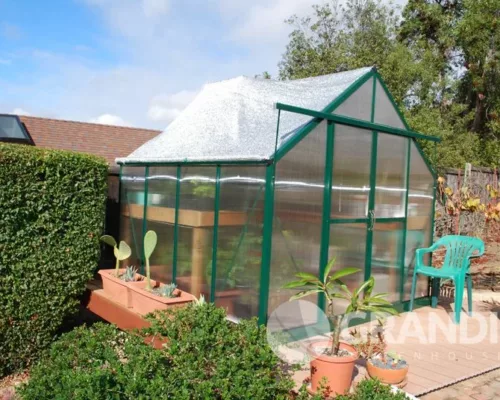 A Grandio shade net covering an Ascent greenhouse to help with controlling temperature and humidity in the greenhouse.